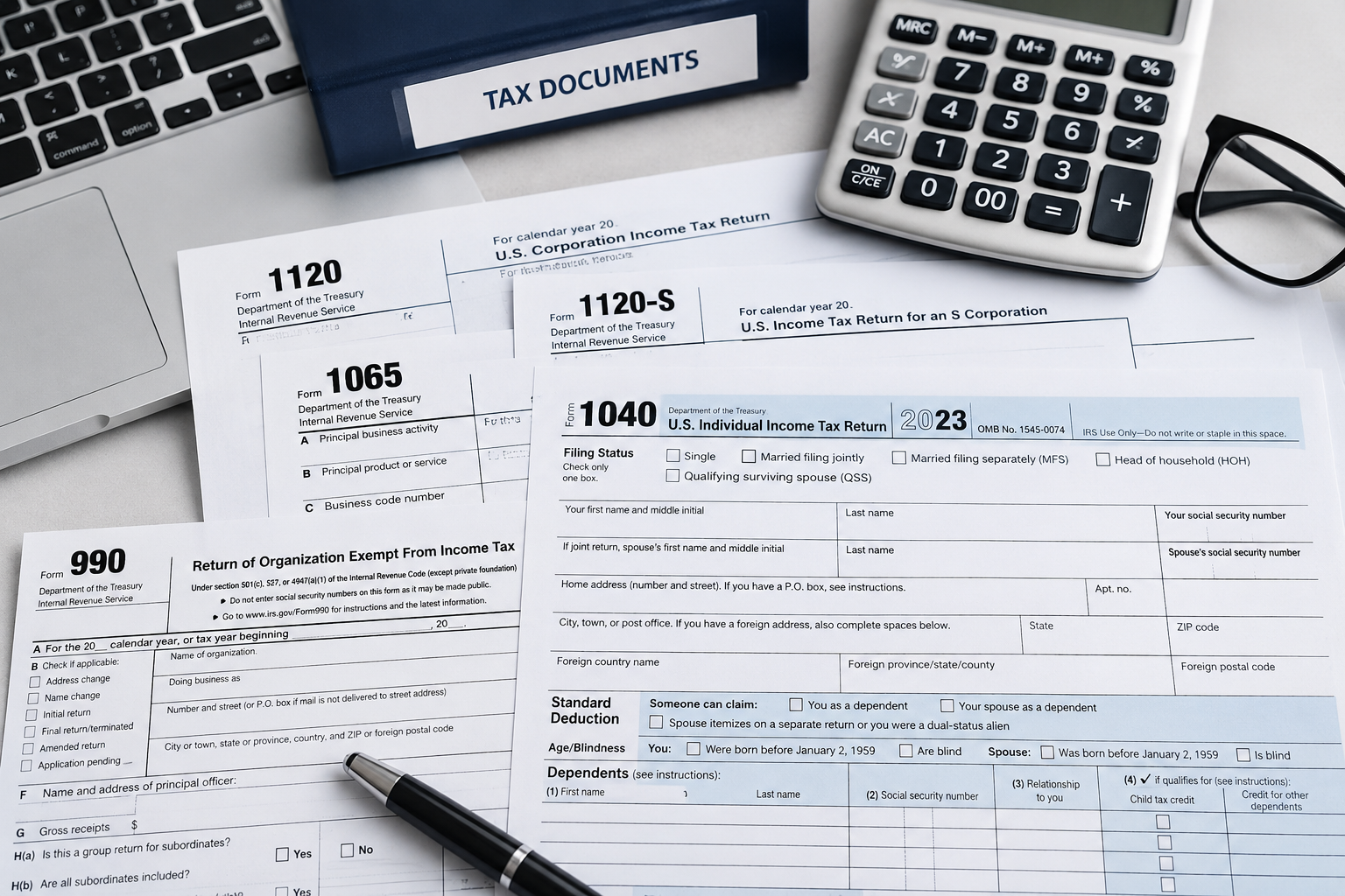 Professional tax preparation workspace with federal tax forms, calculator, laptop, and tax documents